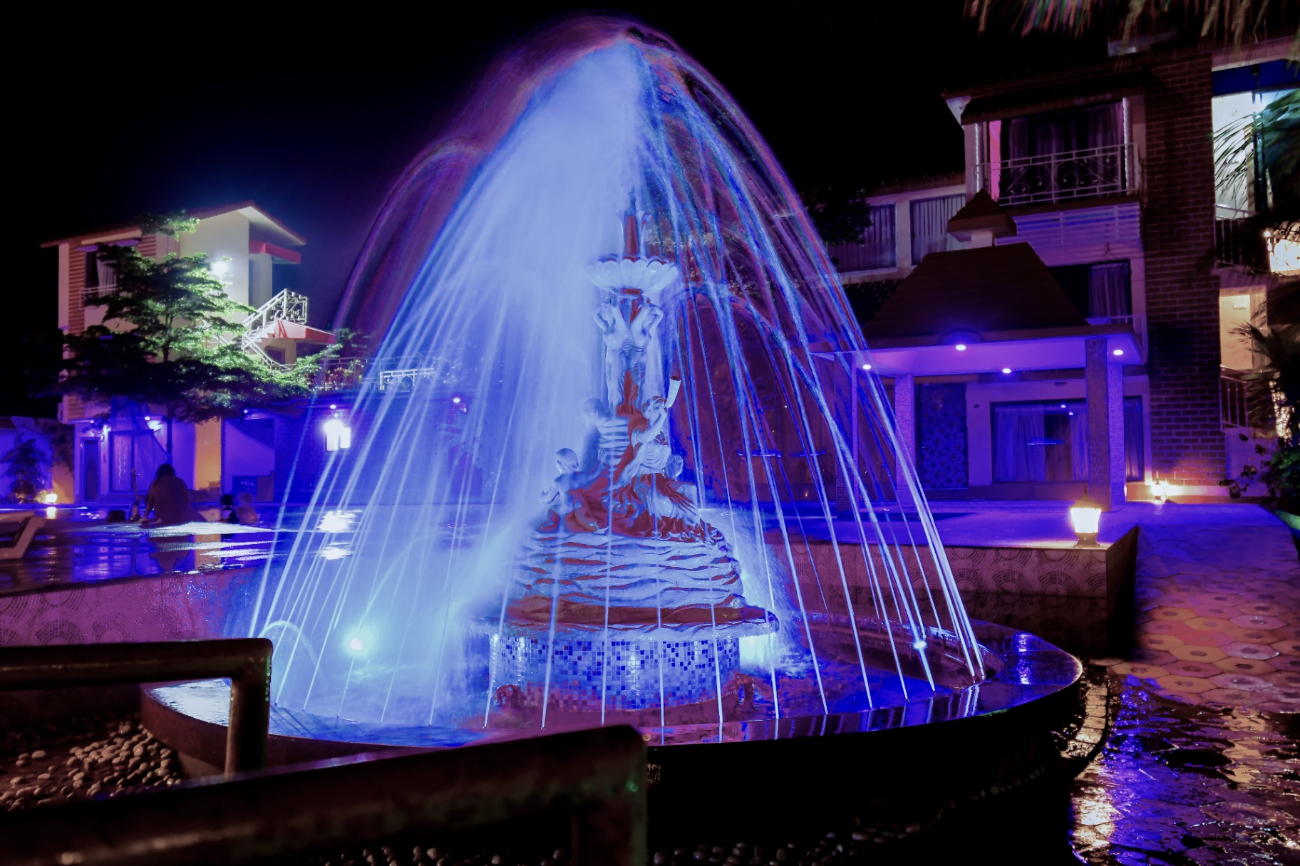 Centerpiece fountain glowing in vibrant blue at night